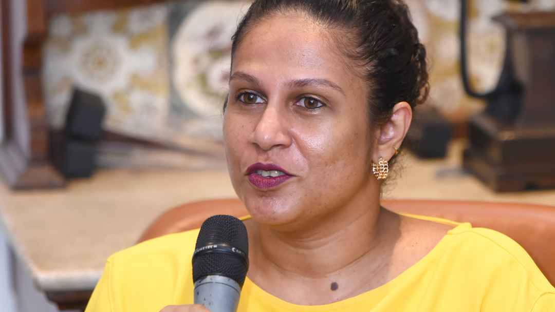 Women holds microphone and shares opinion