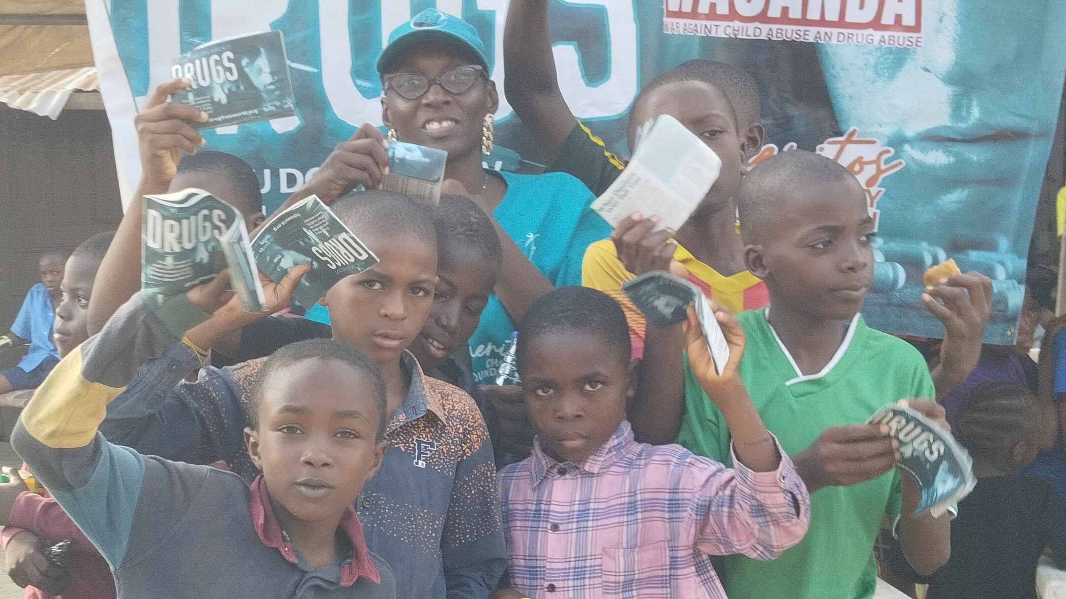 Dr. Toluwalope with children during International Day of the Boy Child