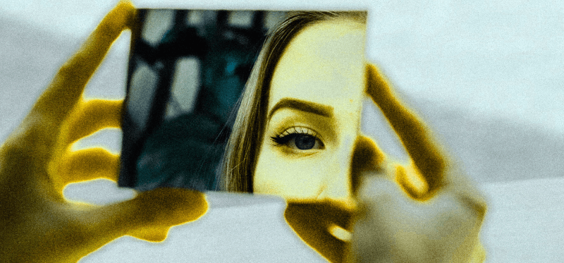 a drawing of a woman holding up a mirror to herself