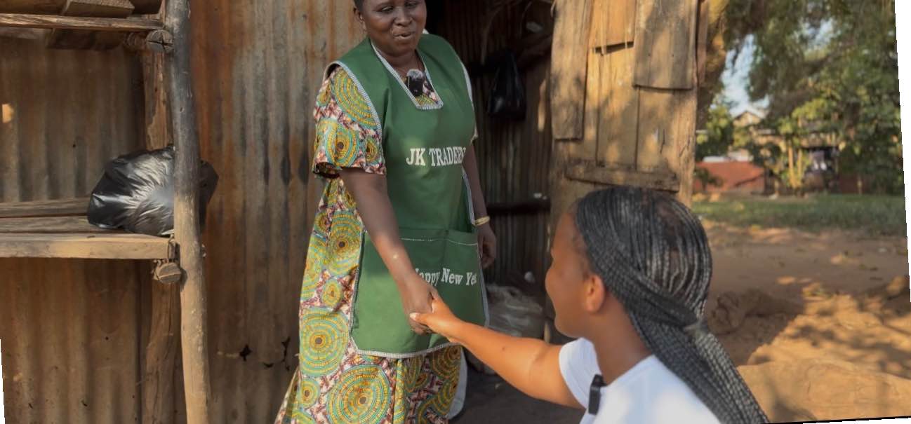 A volunteer from New Day Initiative speaks with a community member during an outreach visit, reflecting compassion, hope, and human connection.