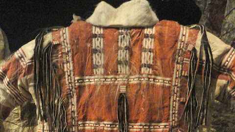 a tradtional Unagax outfit in rust and cream