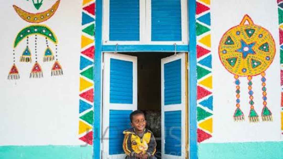 A nubian boy is looking from the window