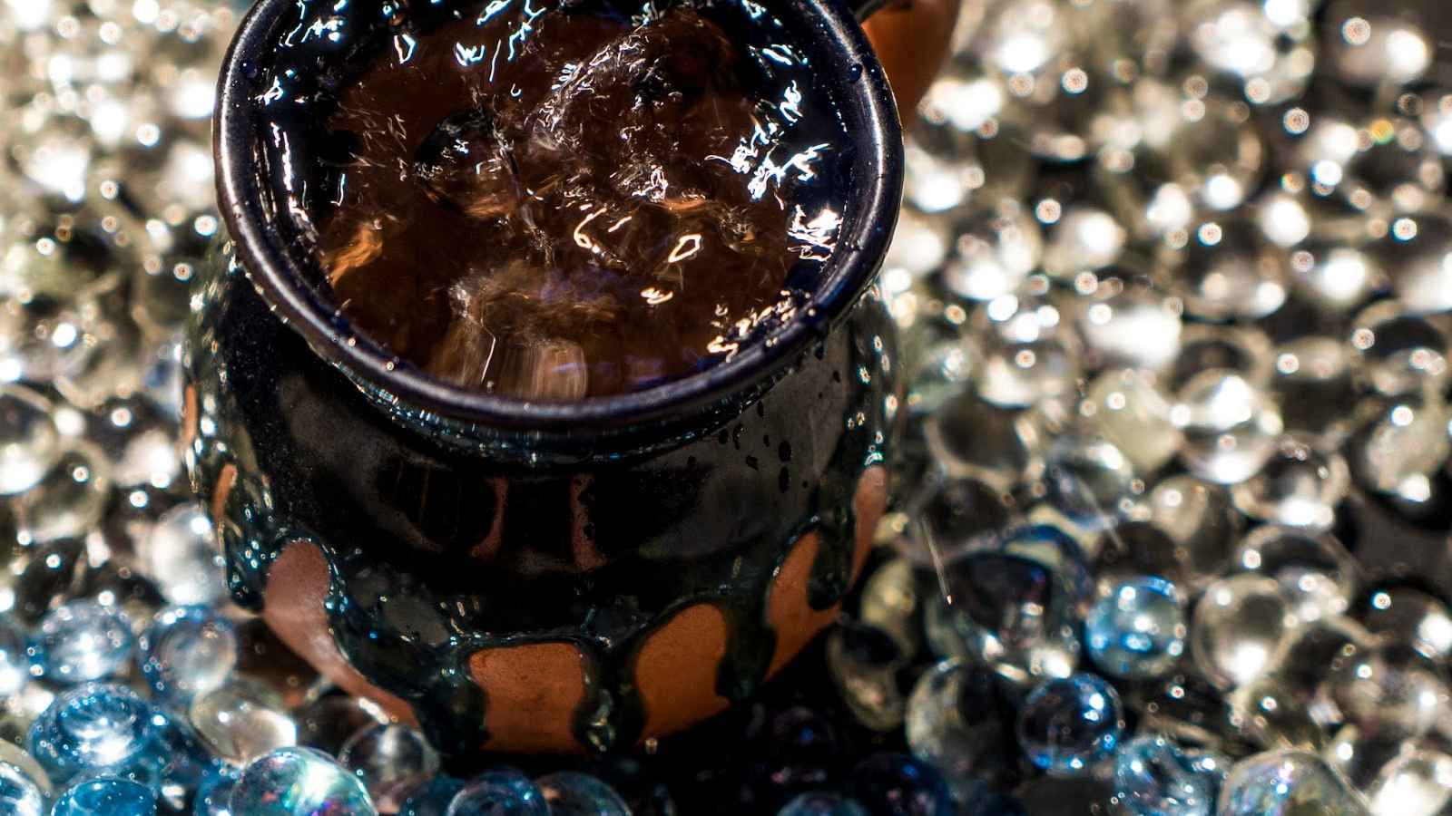 glass pebbles and a glass of ice water