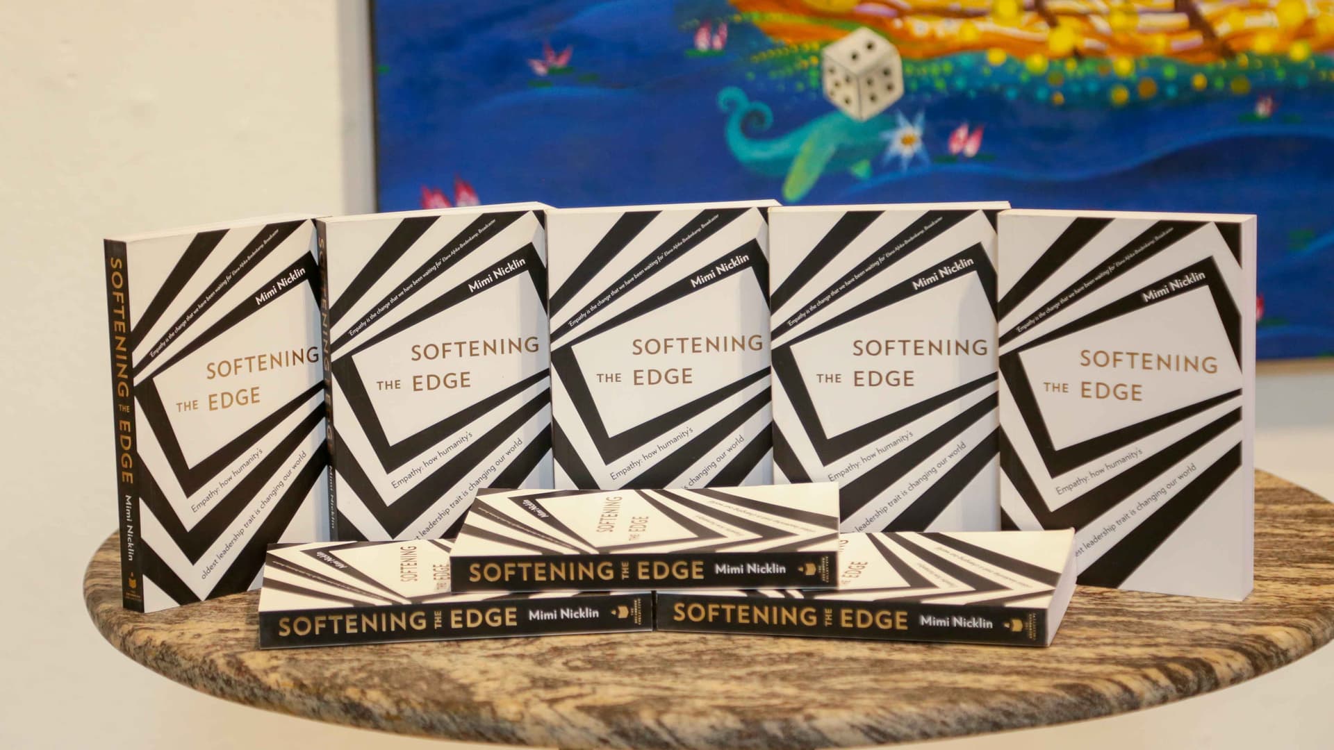 5 of the authors books, Softening The Edge, are on a table