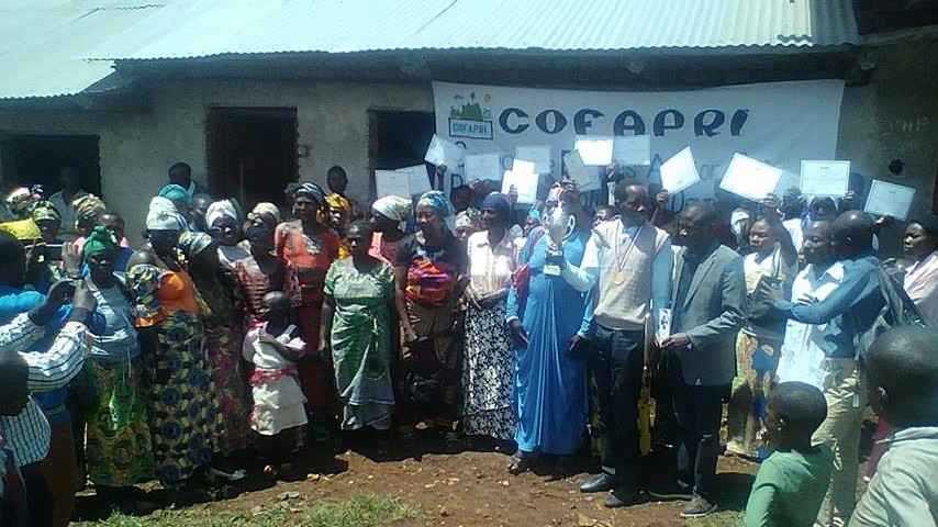 Dr Mugisho with women after decorating him for good work