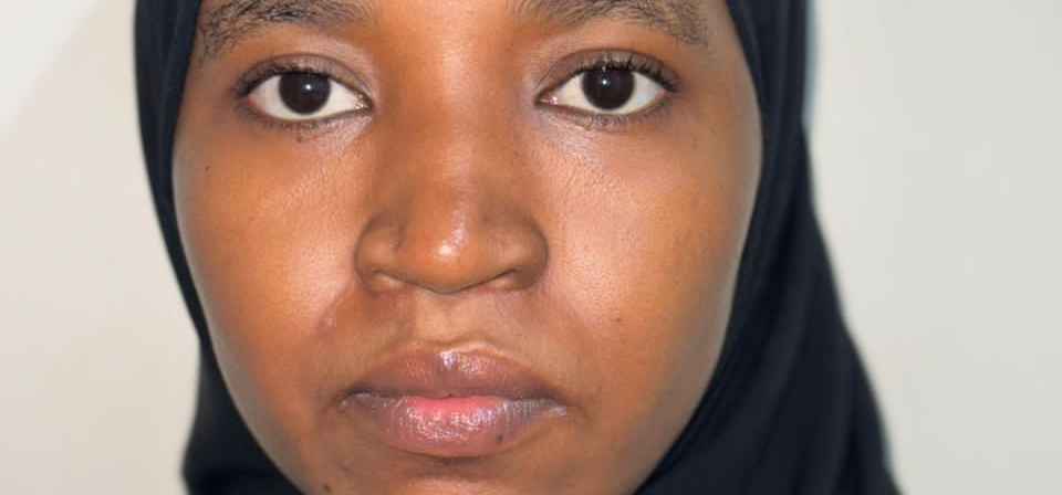 "Close-up photo of a young woman’s eyes, looking forward with a calm and determined expression.