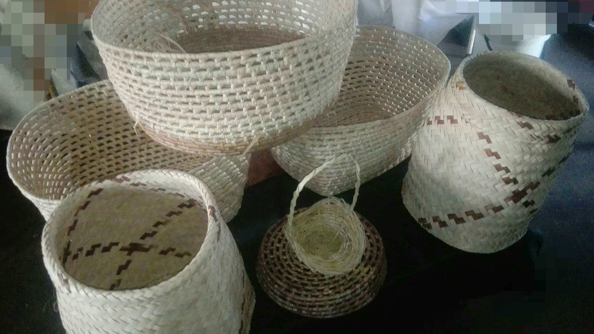 A photo of beautifully crafted baskets woven by my mother and her students