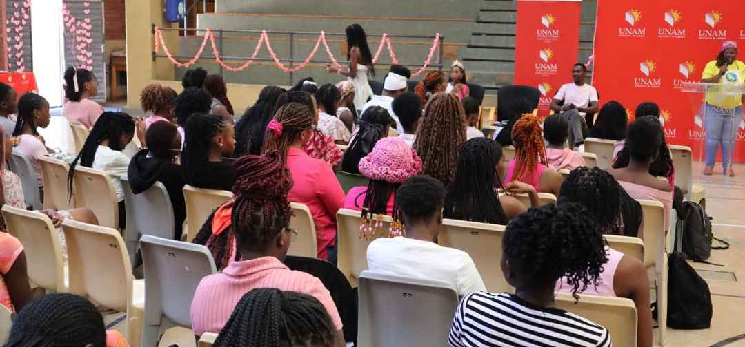 peaker stands in front of female students UNAM Gym Hall, talking about ''Peace and inner Glow'' during the Inter national Women's Day pad project launch.