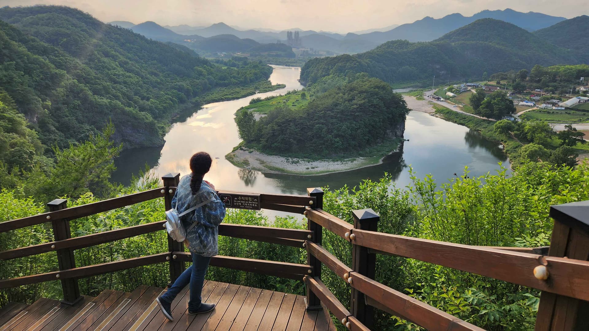 Woman looking at the Korean Peninsula‑shaped Cliffs in Yeongwol, South Korea