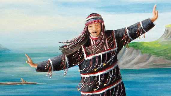 An Unangax girl by the beach with arms outstretched as if she is flying
